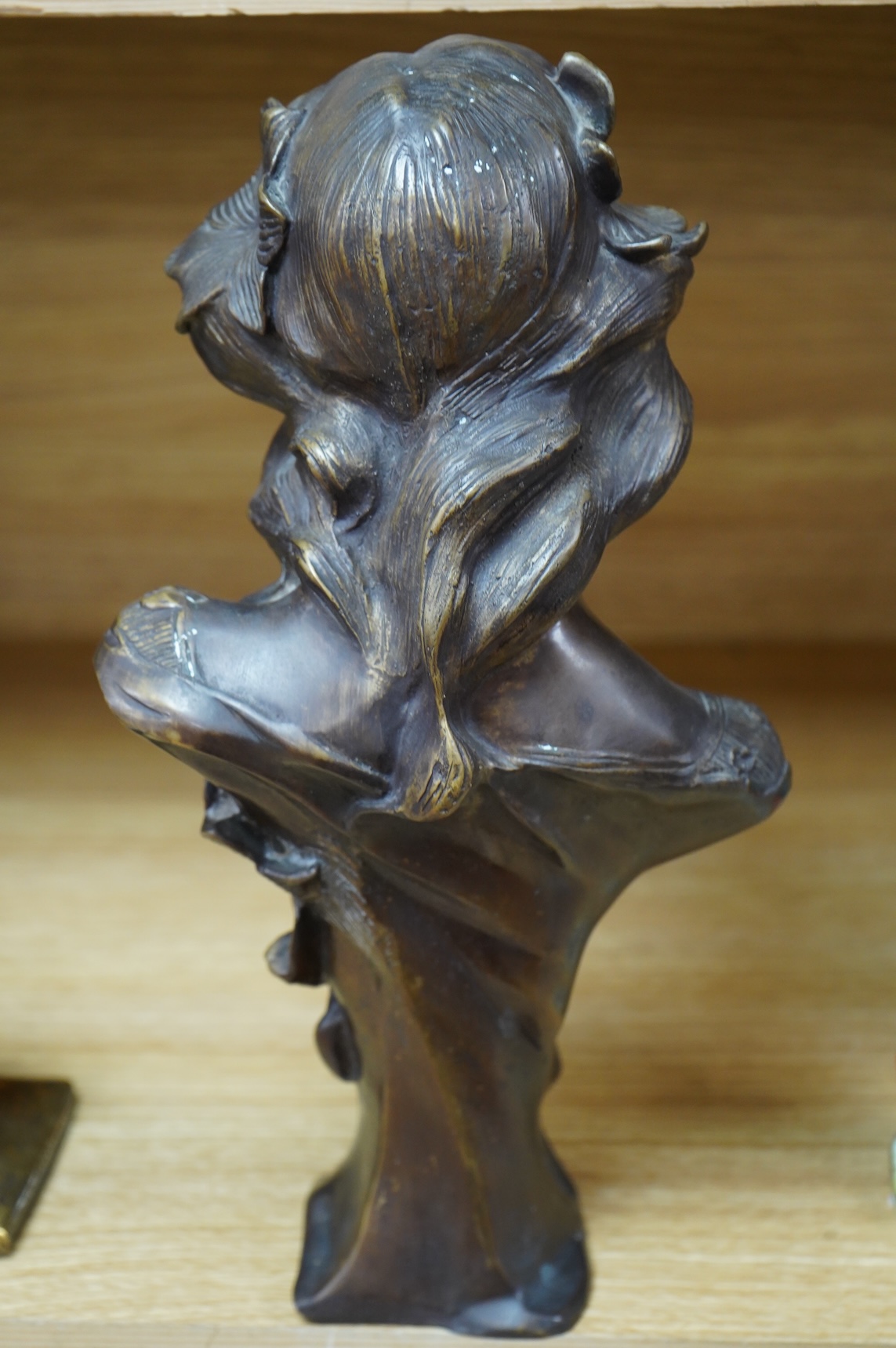 A French Art Nouveau bronze bust of a maiden, unsigned, 32cm high